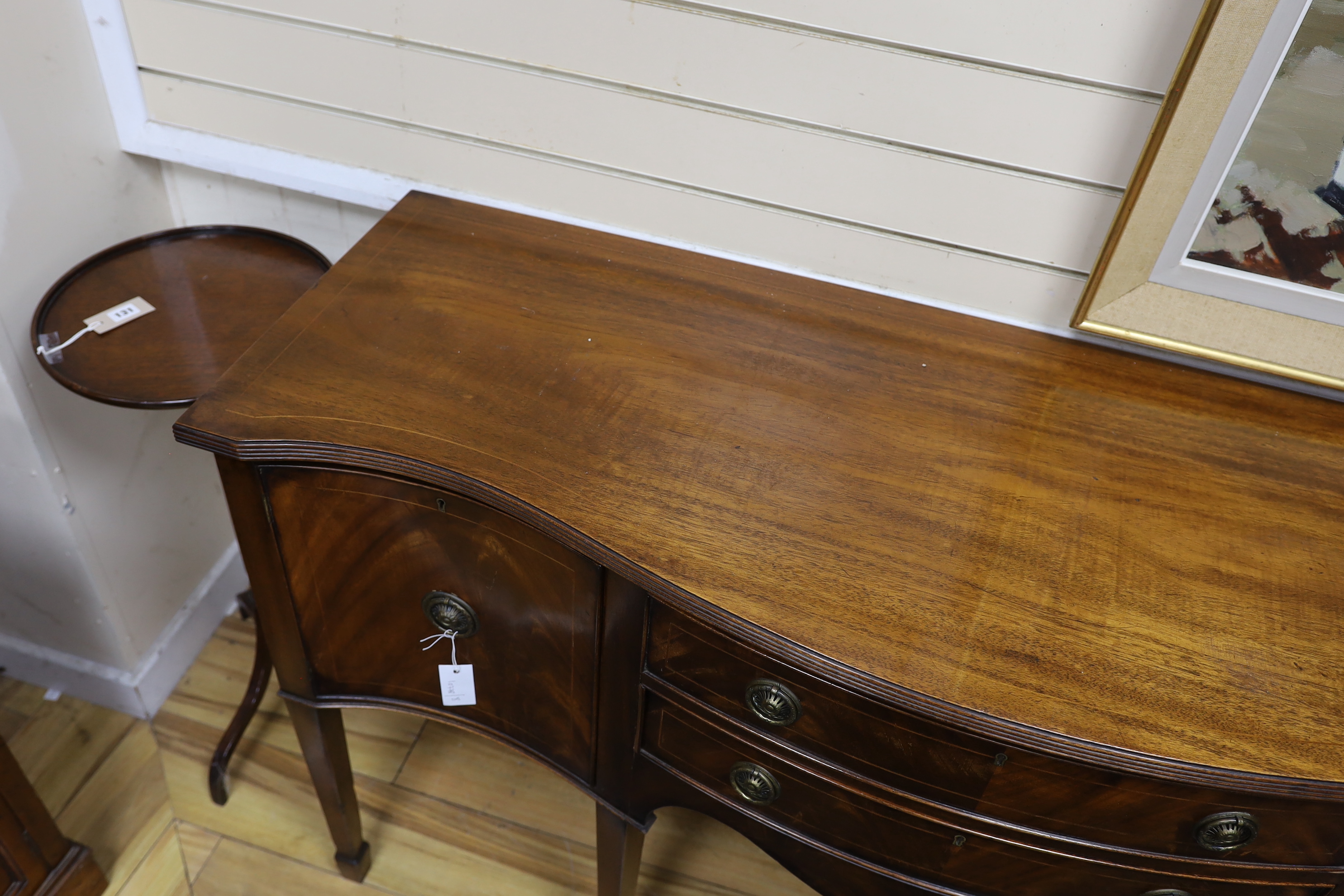A George III style mahogany serpentine sideboard, length 152cm, depth 52cm, height 89cm